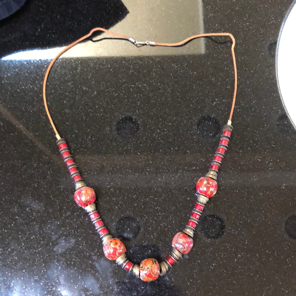Red enamel beads on leather necklace